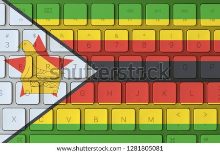 Zimbabwe flag and computer keyboard in the background