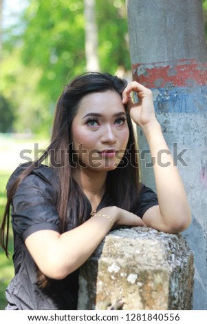 Portrait shot of Asian women with long hair at the park.
