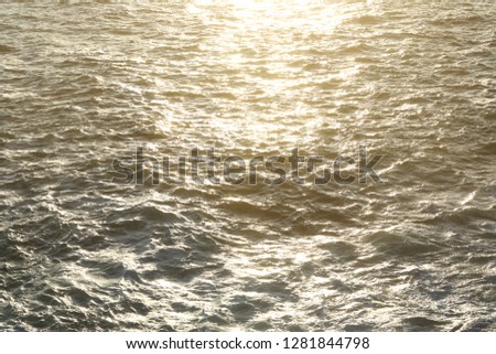 In the sea waves reflect the sun rays.