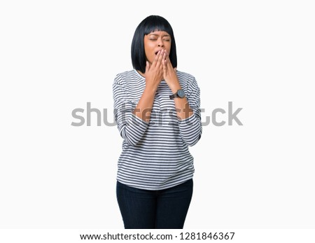 Beautiful young african american woman wearing stripes sweater over isolated background bored yawning tired covering mouth with hand. Restless and sleepiness.