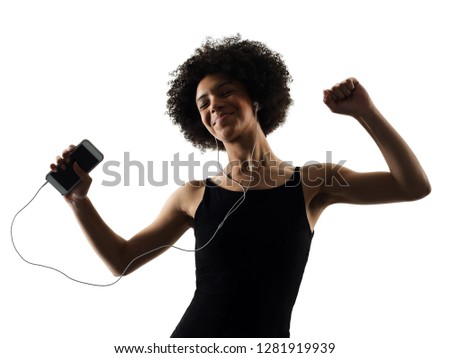 one mixed race african young teenager girl woman happy dancer dancing  listening music in studio shadow silhouette isolated on white background