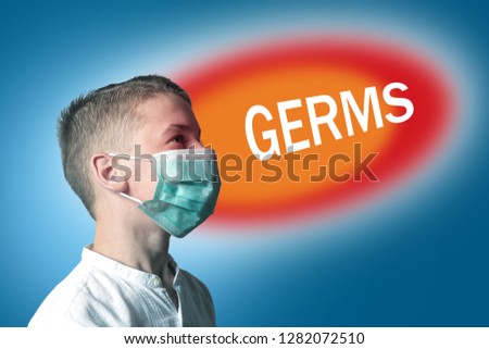 Little boy in a medical mask on a bright background with inscription GERMS.