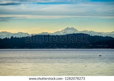 A view of the Olympics Mountain across the Puget Sound at sunset.
