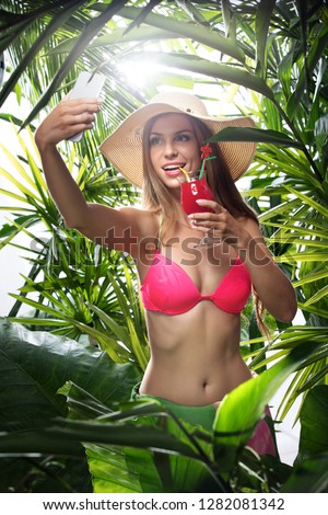 portrait of nice young woman is hanging in tropical jungle