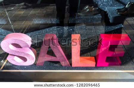 Sales sign on the vitrine. Big different colored letters saying sales. Living coral color. Colorful mock-up.