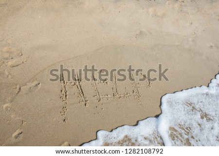 inscription on wet sand near the sea
