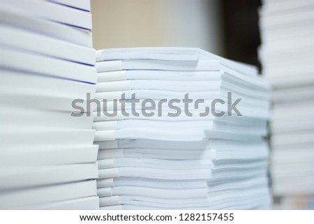 a pile of white paper sheet on the table ready for printing
 Royalty-Free Stock Photo #1282157455