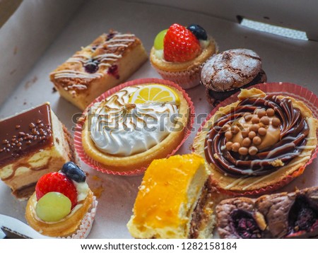 Colorful assortment of desserts, pastries and cake.    Lemon tart, tiramisu, meringue cookies and cake.