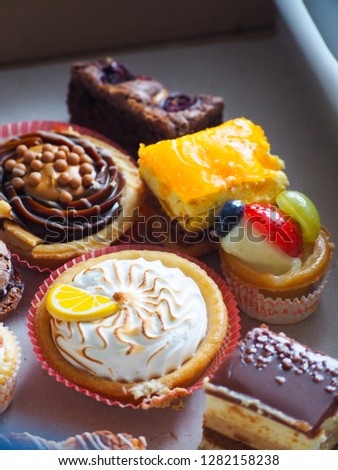 Colorful assortment of desserts, pastries and cake.    Lemon tart, tiramisu, meringue cookies and cake.