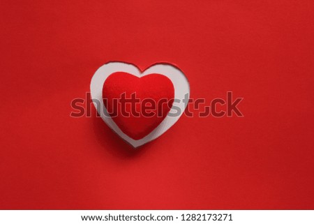 Red Paper Background for design to Valentine's Day. Decorative heart from red felt. View from above. Valentines Day concept