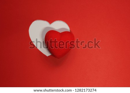 Red Paper Background for design to Valentine's Day. Decorative heart from red felt. View from above. Valentines Day concept