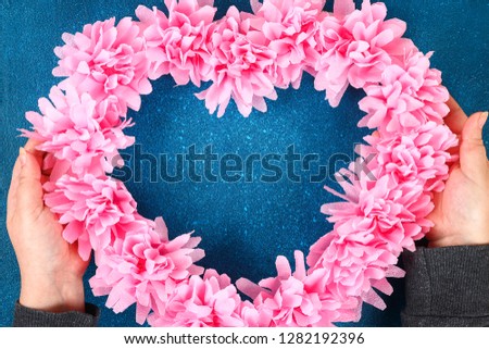 Heart shaped wreath decorated artificial flower made pink tissue paper napkins. Gift ideas for Valentines Day, decor for day love, concept February 14. Step by step. process children crafts. Top view