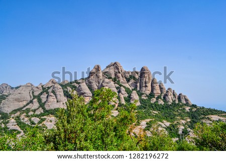 Mountains Montserrat, Catalonia Spain. Montserrat mountain system near Barcelona. Massive bald mountains with sparse vegetation, through which the cable car runs to the mountain abbey.