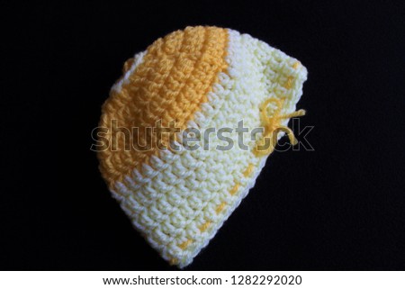 a cute toddler crochet hat on a black background