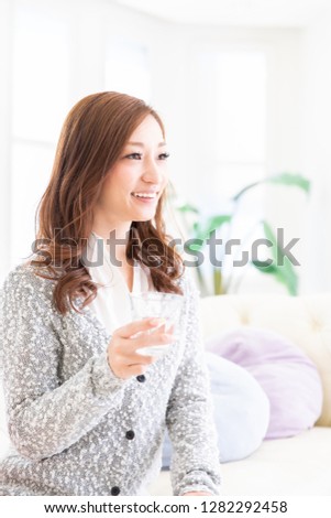 young attractive asian woman who drinks water