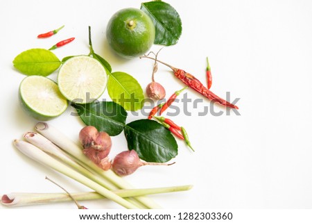 Ingredients of Thai spicy food "Tomyum" spicy soup. lemon, chilli, Red onion, lemon grass, Kaffir, lime leaves. Top view, copy space. 