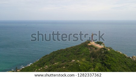 Aerial view of Dai Lanh beach and Mui Dien light house in a sunny day, MuiDien, Phu Yen province - The eastermost of Vietnam. Stock photo image top view of Mui Dien lighthouse on fractured rocky cliff