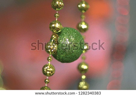 Green ball on a pink background in beads