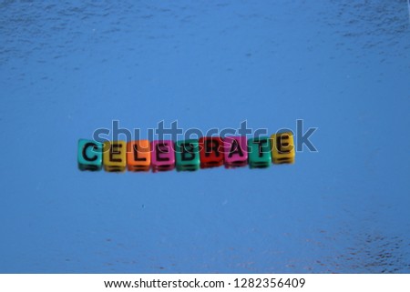 Celebrate spelled alphabet blocks 3d message in primary color abc beads.