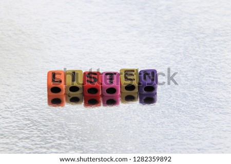 Listen word spelled alphabet blocks 3d message in primary color abc beads.