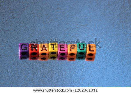 Grateful thank you word spelled alphabet blocks 3d message in primary color abc beads.