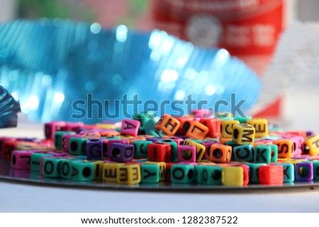 Scattered abc alphabet word letter blocks beads in colorful primary colors. 