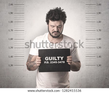 Caught guilty man with ID signs on his hand. Royalty-Free Stock Photo #1282415536