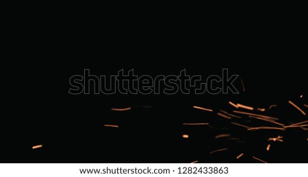 hot sparks floating from side on black background