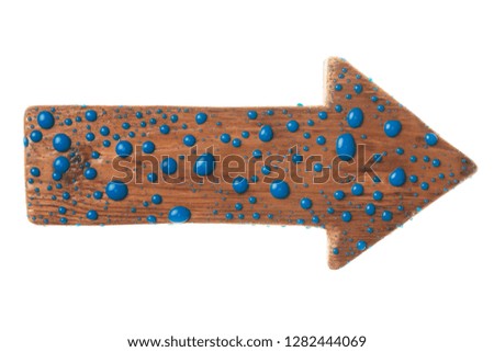 Wooden signpost with drops of blue paint. Isolated on white background