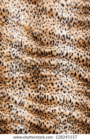 Leopard print fur blanket background rippled in vertical position