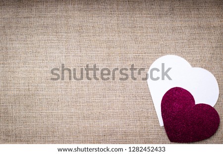 Valentines day background - white and rose hearts on grey matting background, top view, flat lay.  Birthday, Mothers day or other celebration concept.  Congratulations background with space for text.