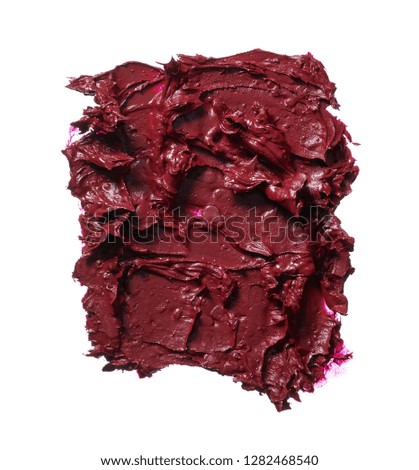 Smear of burgundy red lipstick or acrylic paint isolated on white background