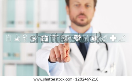 Doctor hand touching medical care text, symbols and icons on virtual screen