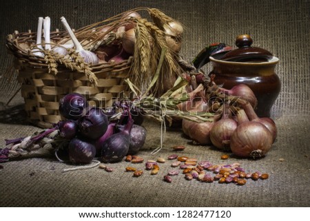 Traditional Russian cuisine. On a brown background basket, onions, garlic, ears of wheat. Close-up