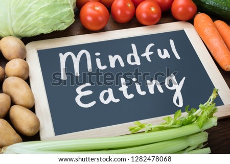 Close-up Of Mindful Eating Text On Slate Surrounded With Organic Vegetables Royalty-Free Stock Photo #1282478068