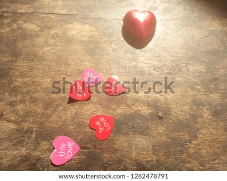 A heart-shaped on an old wooden table used as a background or Valentines Day card.