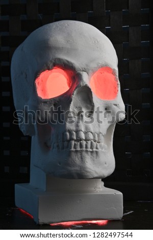 Cast of a human skull. Smoke from the eyes. A piece of interior