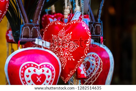 Closeup view of red jewelry hearts with white patterns