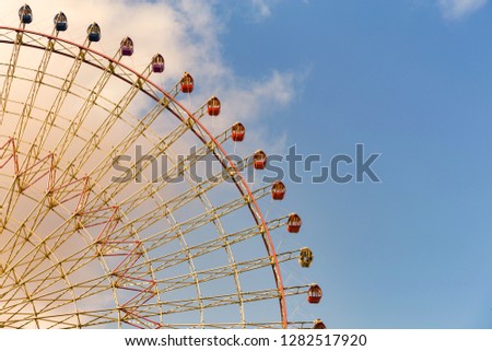 Modern ferris wheel with blue sky background