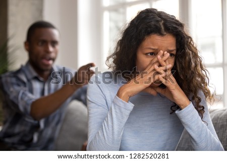 Upset abused african wife tired of fighting ignoring controlling despot husband feeling frustrated depressed thinking of divorce, sad girlfriend desperate about bad relationships family conflicts Royalty-Free Stock Photo #1282520281