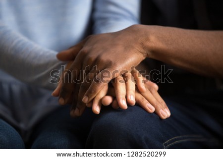African american black couple husband and wife holding hands as psychological counseling support concept, understanding care in love, comfort empathy honesty trust in relationships, close up view Royalty-Free Stock Photo #1282520299