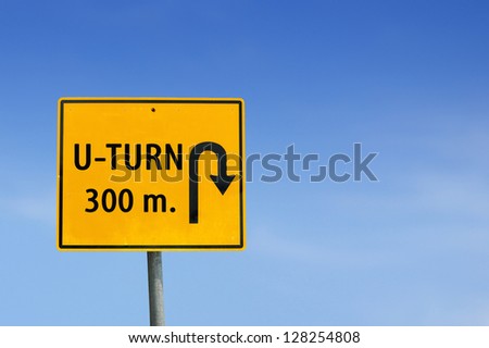 U turn road sign on sky background