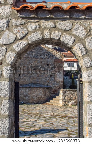 The Architecture of Ohrid. A view of the cobblestone court and church through a stone gate. In the Old Town, Macedonia.