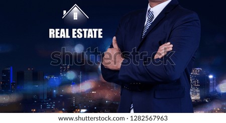 Property insurance and security concept. Real estate agent business with symbol of house on city night background.