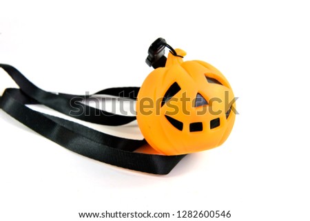 Close up of lanyard with halloween plastic pumkin isolated on white background, selective focus. 
