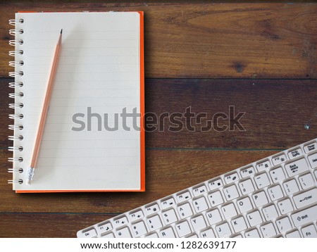 office table with notebook, computer keyboard. (Financial business concept)
