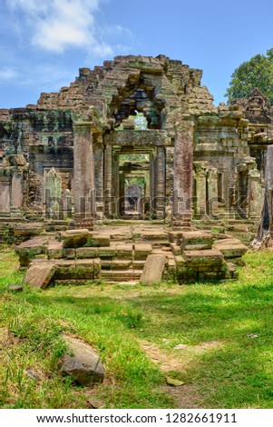 Ruin archway on the eastern side of Preah Khan temple on a sunny day. Part of the Angkor Wat complex of temples north of Seam Reap in Cambodia Royalty-Free Stock Photo #1282661911