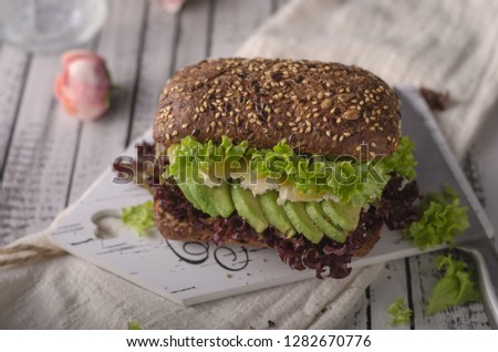 Homemade avocado lettuce sandwich, wholegrain bread, food photography