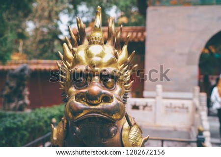 Statue of golden Chinese dragon - guardian of the Forbidden city, Beijing China.