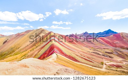Panoramic view of Rainbow Mountain at Vinicunca mount in Peru - Travel and wanderlust concept exploring world nature wonders - Vivid multicolor filter with bright enhanced color tones  Royalty-Free Stock Photo #1282675123